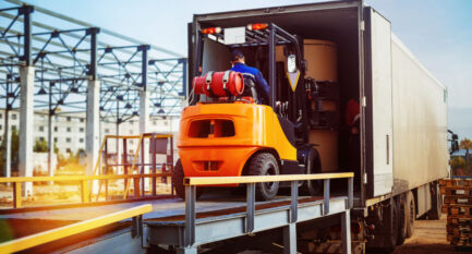 Forklift,Is,Putting,Cargo,From,Warehouse,To,Truck,Outdoors